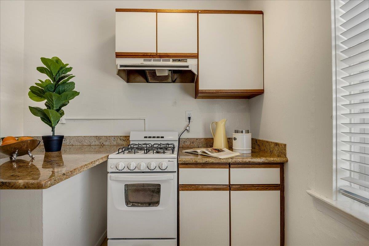 507 Easterby Street Sausalito, CA 94965 - Photo 40 of 90 a kitchen with stainless steel appliances granite countertop a sink a stove and a microwave