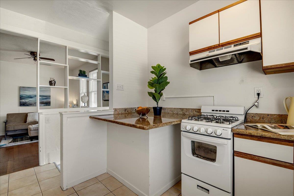 507 Easterby Street Sausalito, CA 94965 - Photo 41 of 90 a kitchen with stainless steel appliances white cabinets and a stove top oven