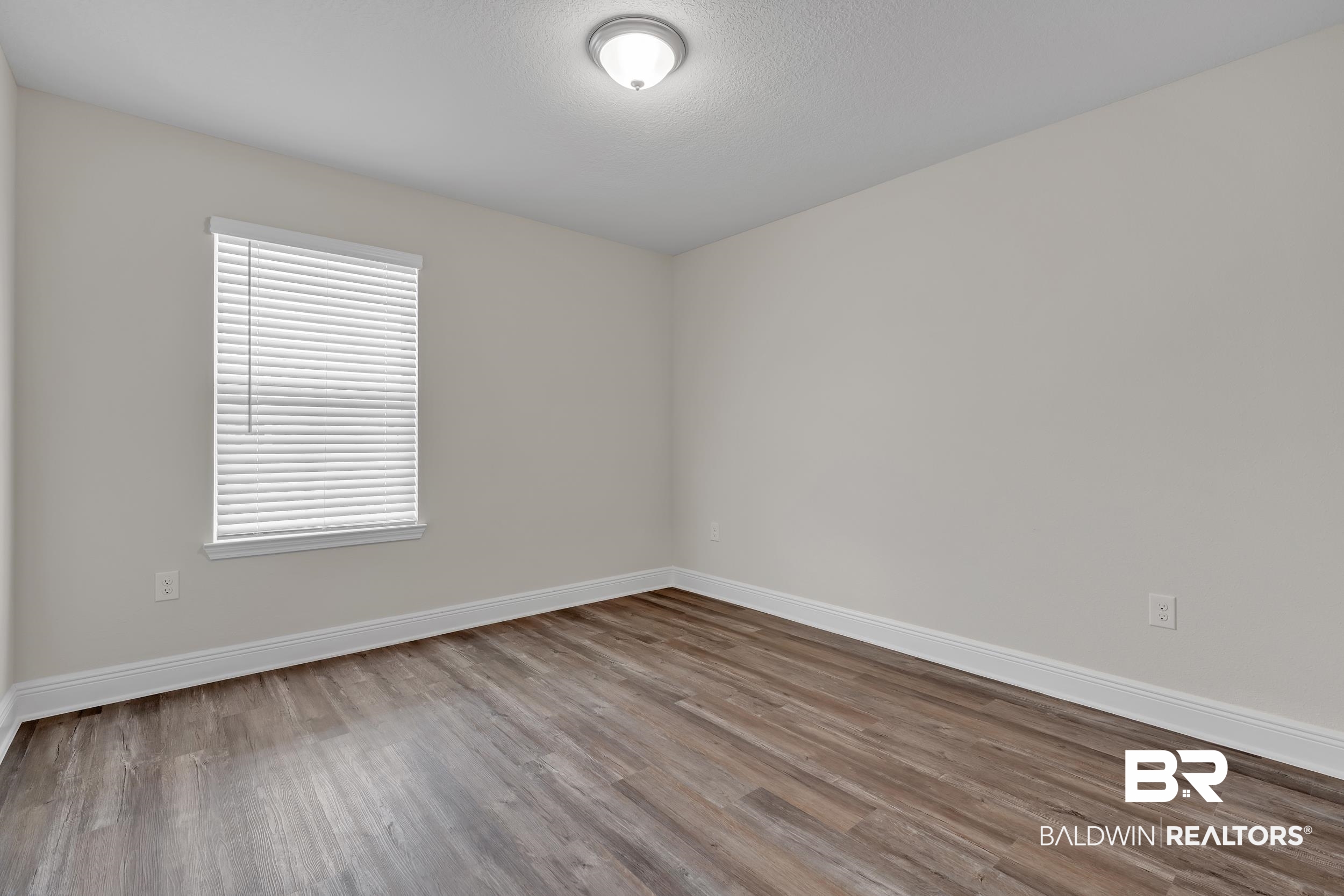24460 Ringneck Loop Elberta, AL 36530 - Photo 30 of 46 Empty room with wood finished floors and baseboards