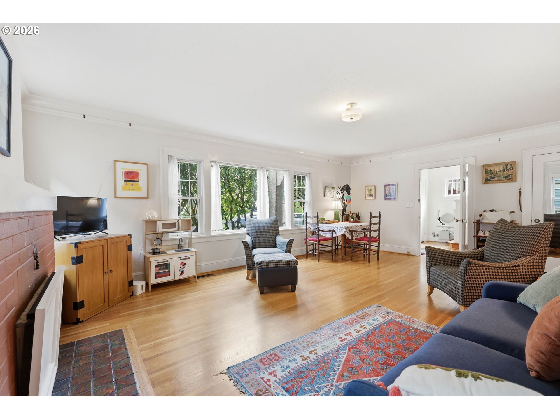 3136 Northeast Couch Street Portland, OR 97232 - Photo 11 of 48 a living room with furniture and a flat screen tv