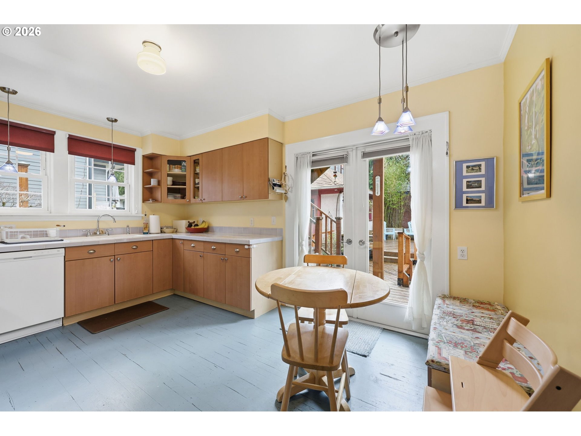 3136 Northeast Couch Street Portland, OR 97232 - Photo 12 of 48 a kitchen with a table chairs sink and cabinets
