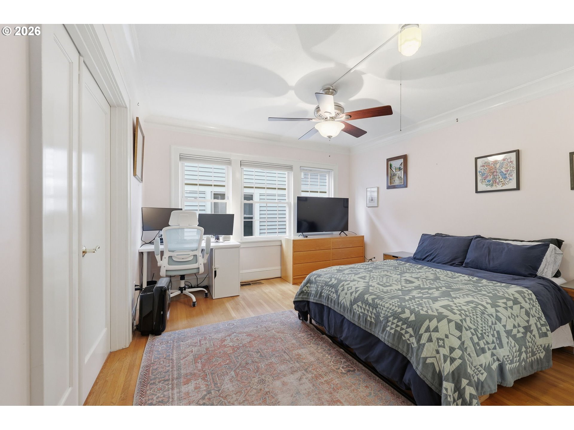 3136 Northeast Couch Street Portland, OR 97232 - Photo 16 of 48 a bedroom with a large bed and a chandelier