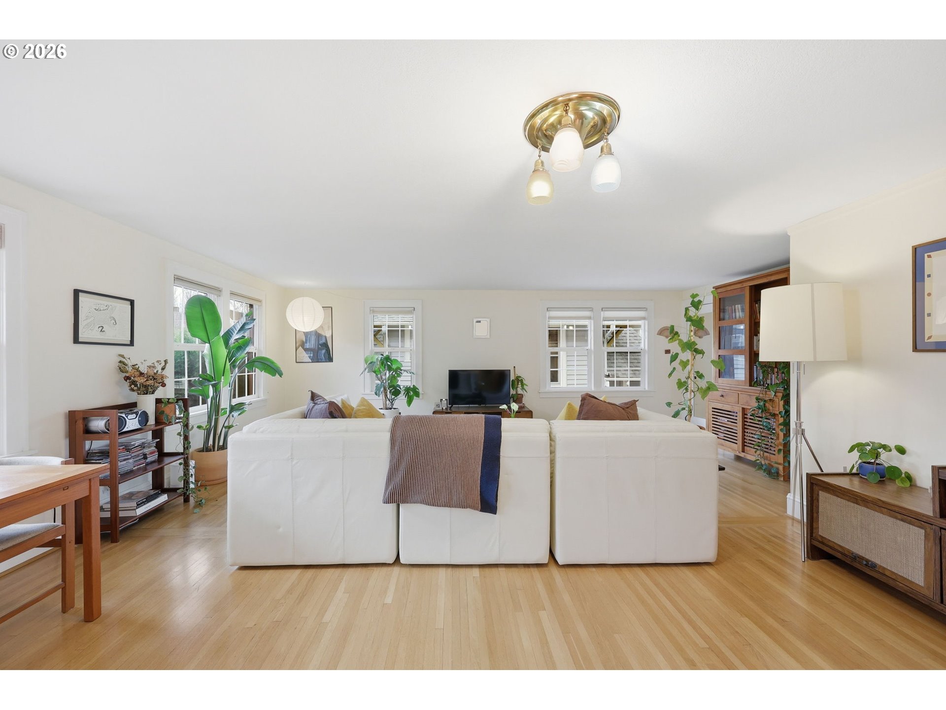3136 Northeast Couch Street Portland, OR 97232 - Photo 24 of 48 a living room with furniture a chandelier and a window