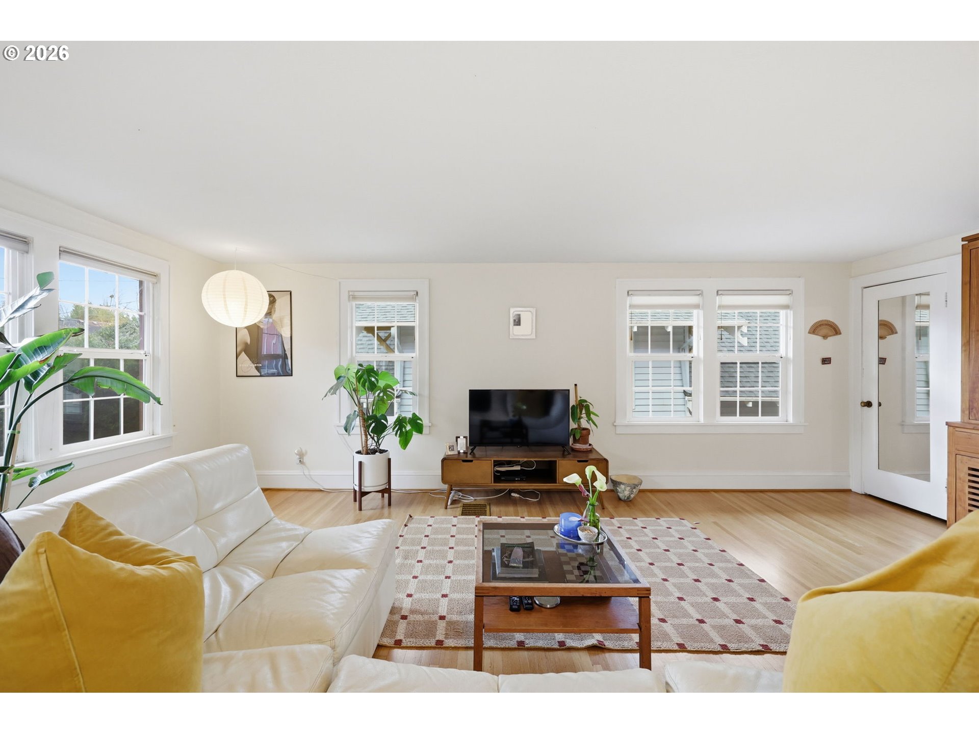 3136 Northeast Couch Street Portland, OR 97232 - Photo 25 of 48 a living room with furniture a flat screen tv and a window