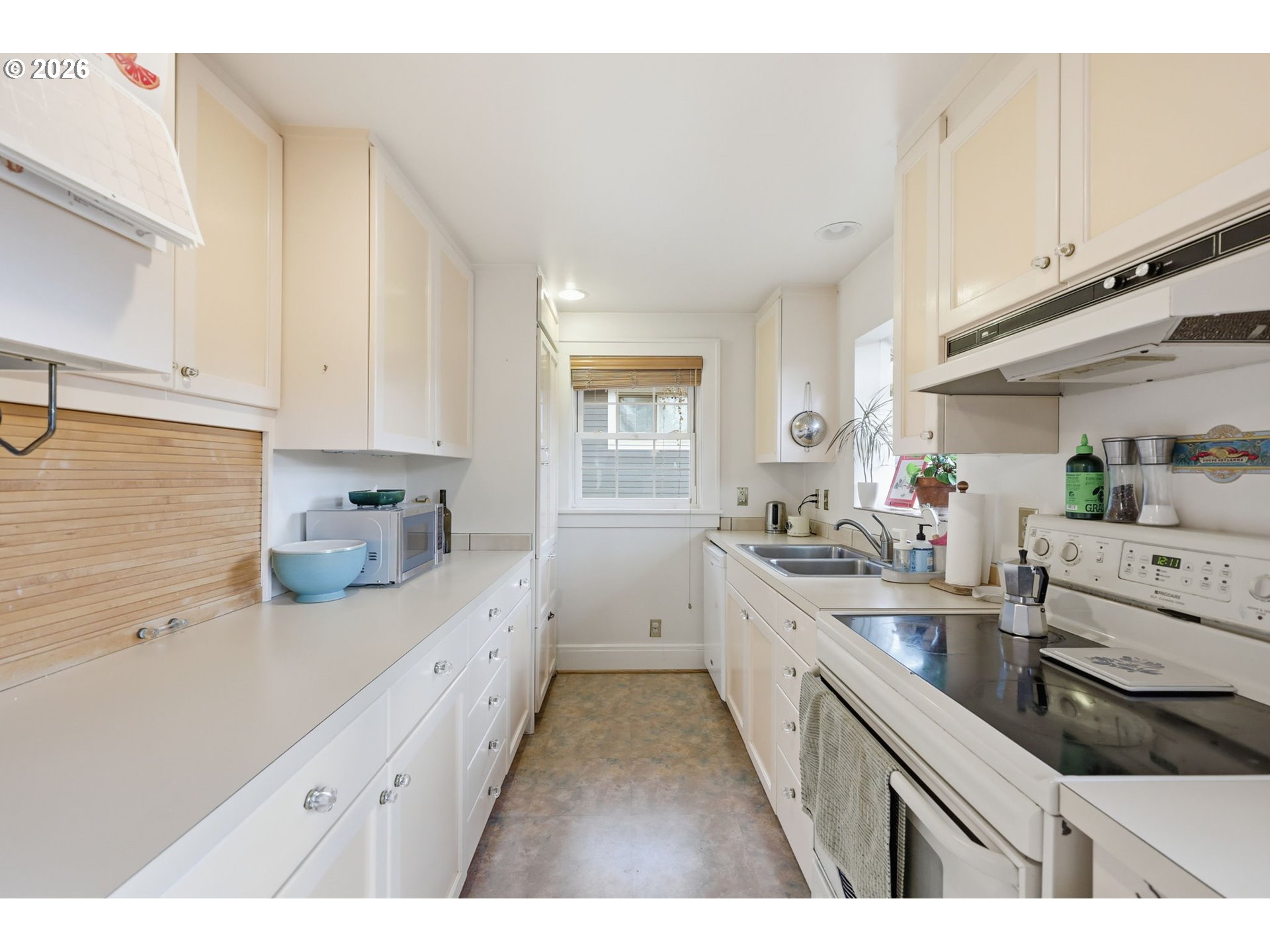 3136 Northeast Couch Street Portland, OR 97232 - Photo 29 of 48 a kitchen with white cabinets and white appliances