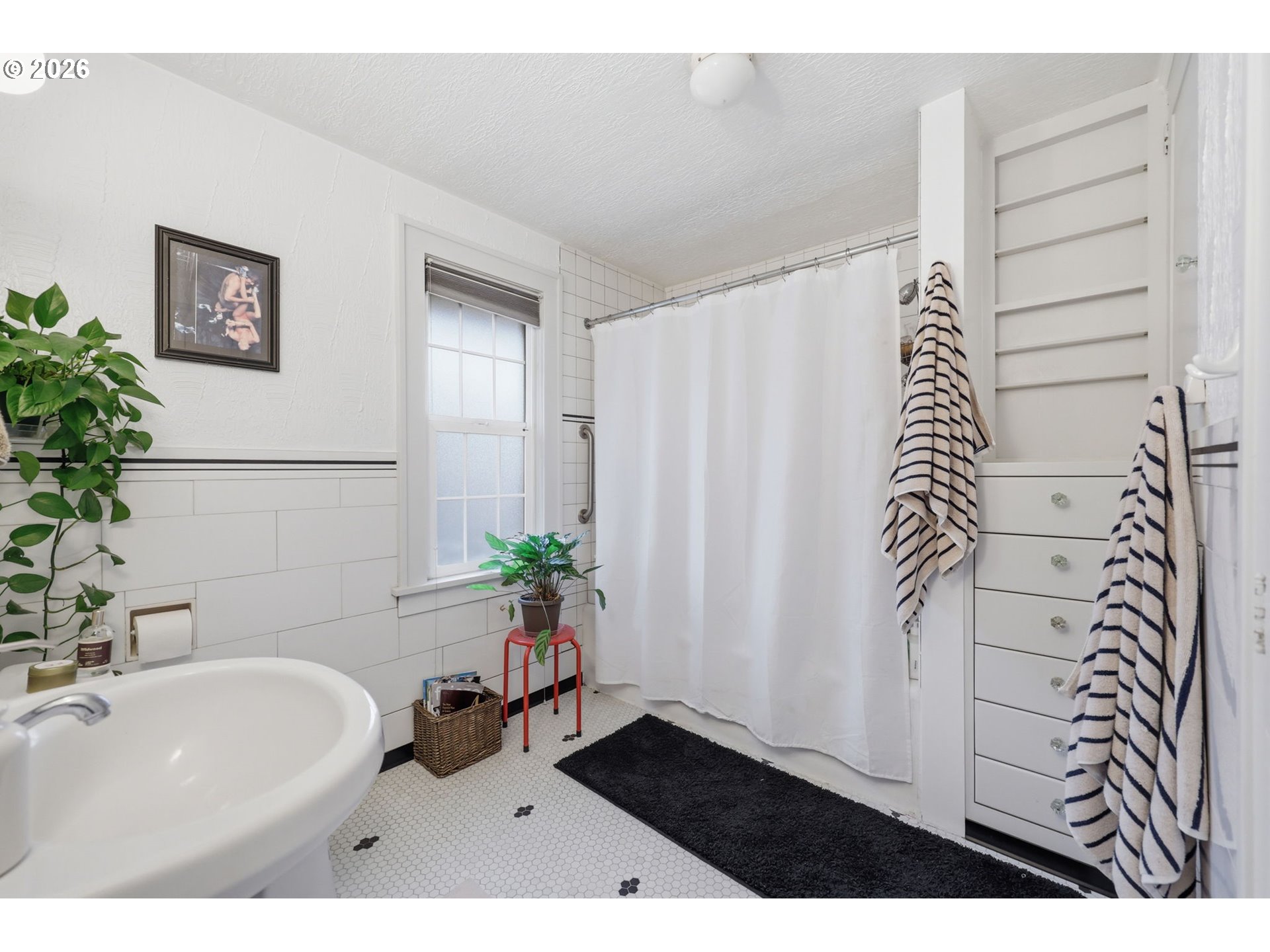 3136 Northeast Couch Street Portland, OR 97232 - Photo 30 of 48 a bathroom with a sink and a tub
