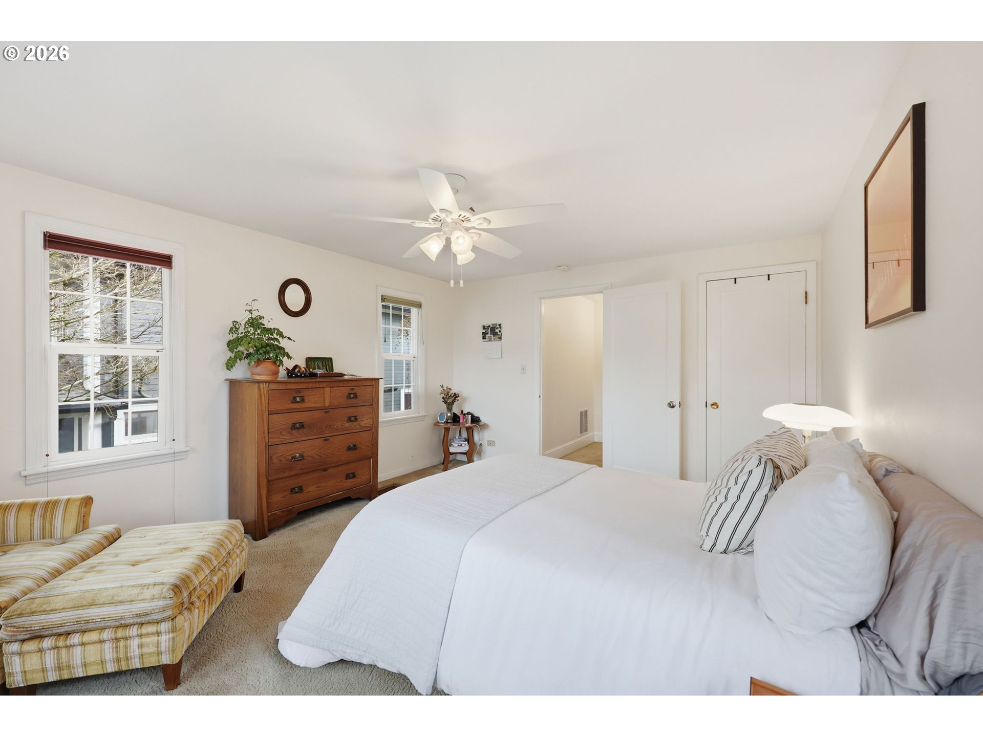 3136 Northeast Couch Street Portland, OR 97232 - Photo 32 of 48 a bedroom with a bed window and a chandelier