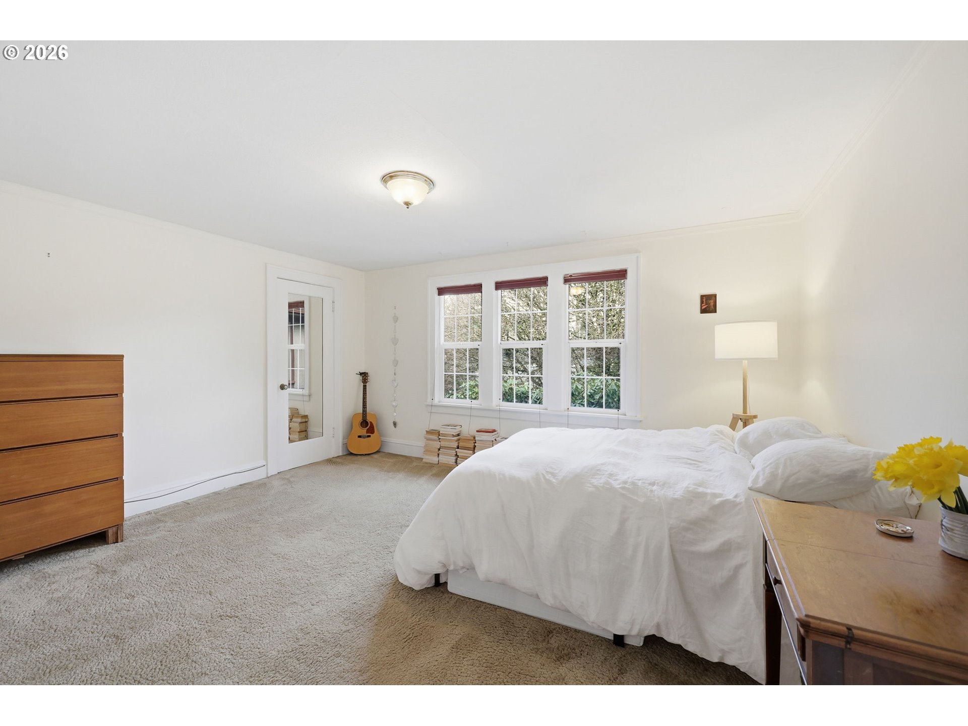 3136 Northeast Couch Street Portland, OR 97232 - Photo 33 of 48 a spacious bedroom with a bed and a window