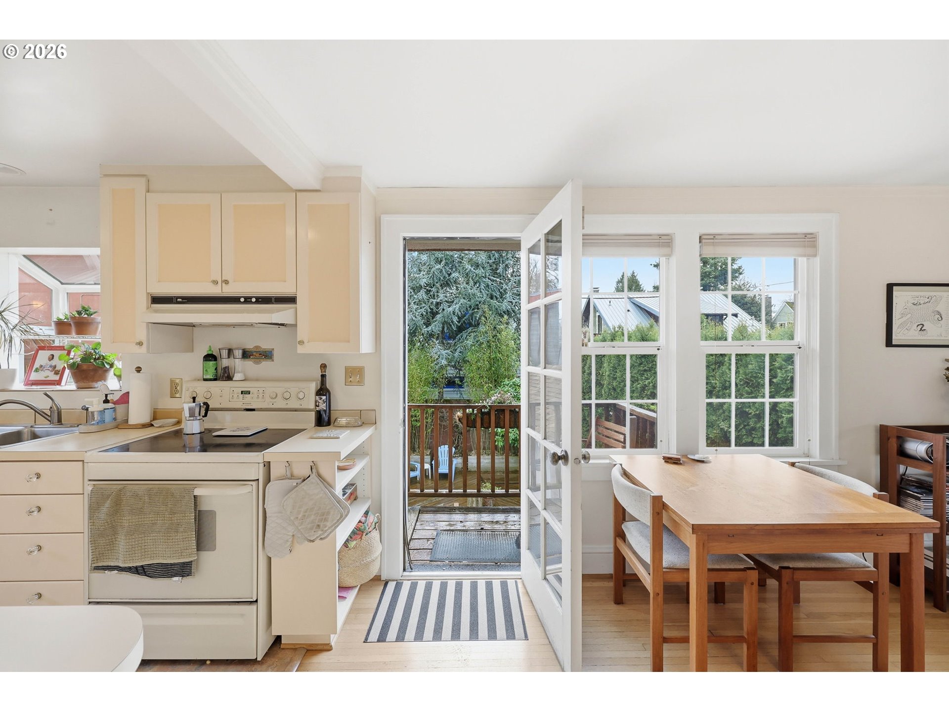 3136 Northeast Couch Street Portland, OR 97232 - Photo 35 of 48 a open kitchen with granite countertop a stove a sink and a refrigerator