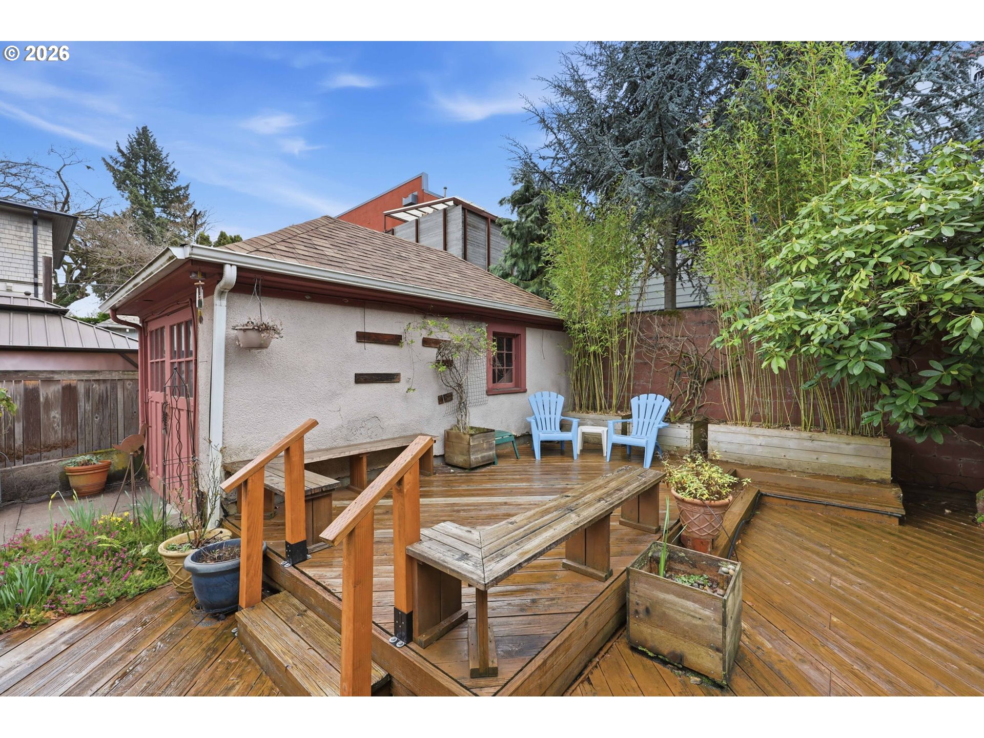 3136 Northeast Couch Street Portland, OR 97232 - Photo 40 of 48 a view of a patio with table and chairs with wooden fence and plants