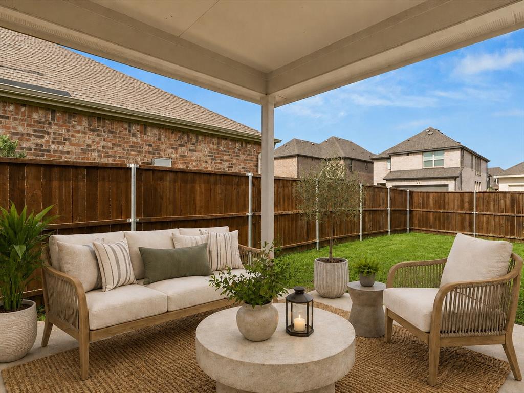 16936 Post Cedar Drive Justin, TX 76247 - Photo 22 of 30 Patio Virtually Staged. Covered patio featuring a concrete slab and a manicured lawn