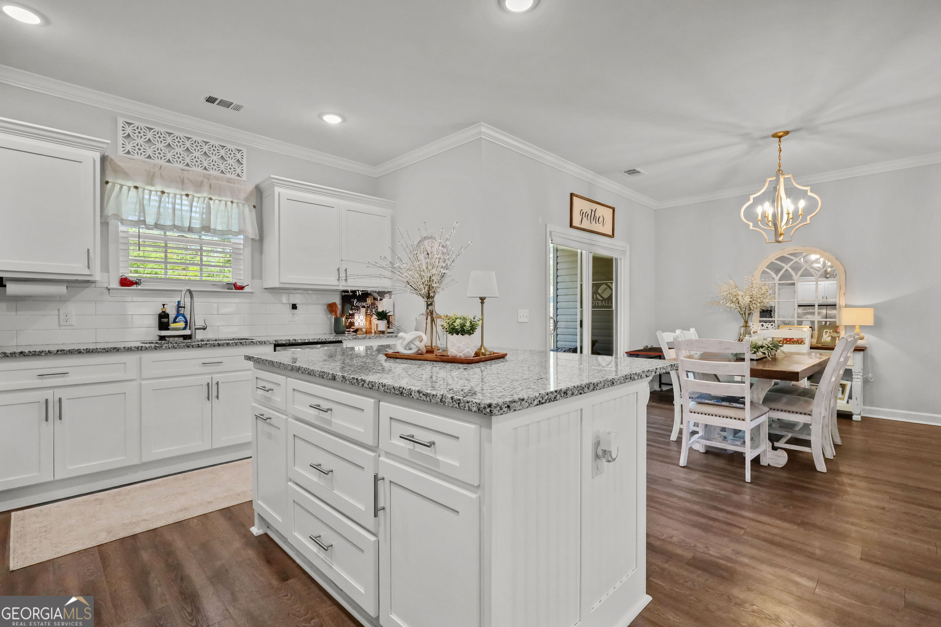 189 Common Way Jesup, GA 31545 - Photo 12 of 30 a kitchen with granite countertop cabinets a sink dining table and chairs