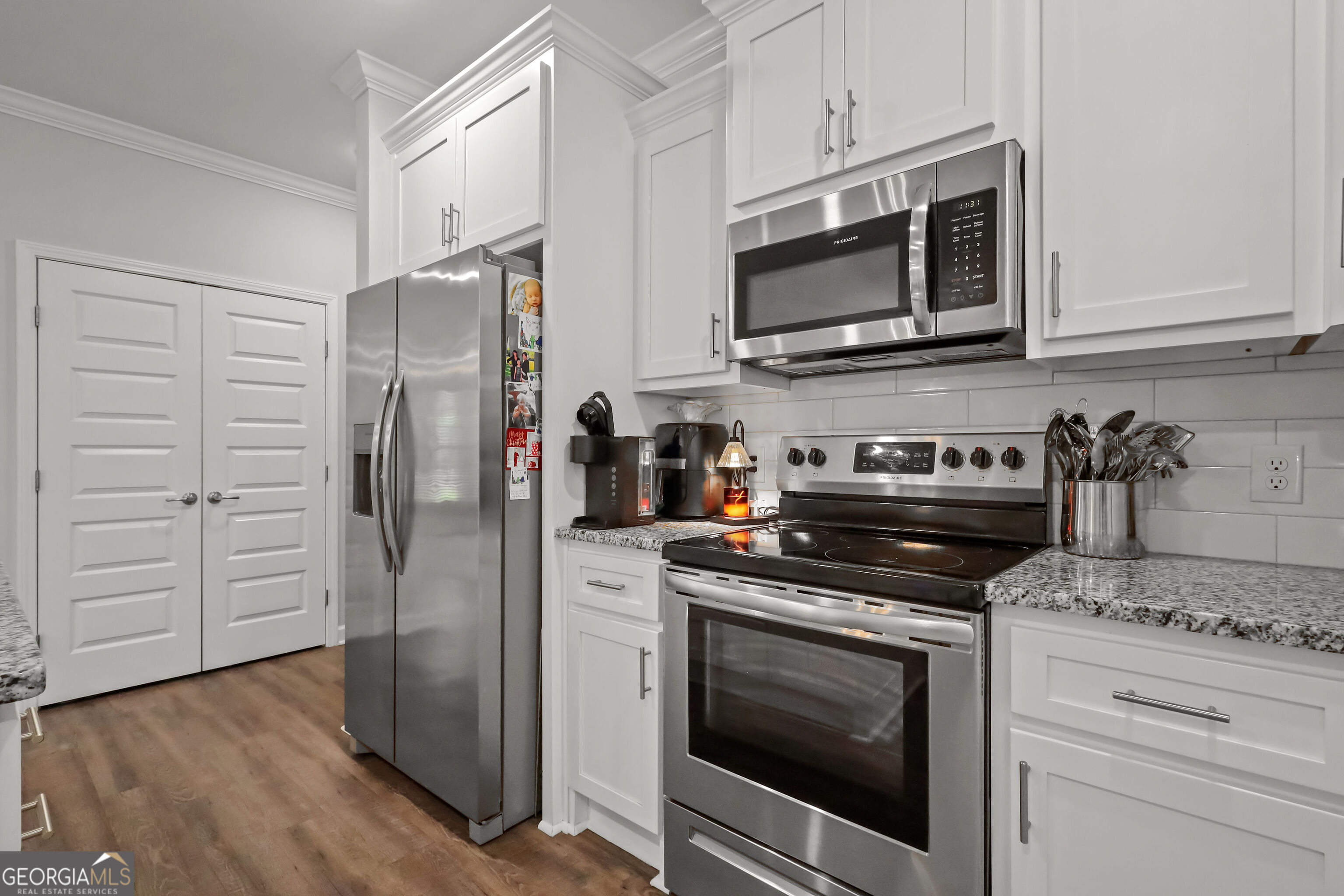189 Common Way Jesup, GA 31545 - Photo 13 of 30 a kitchen with stainless steel appliances granite countertop a stove a microwave and a refrigerator