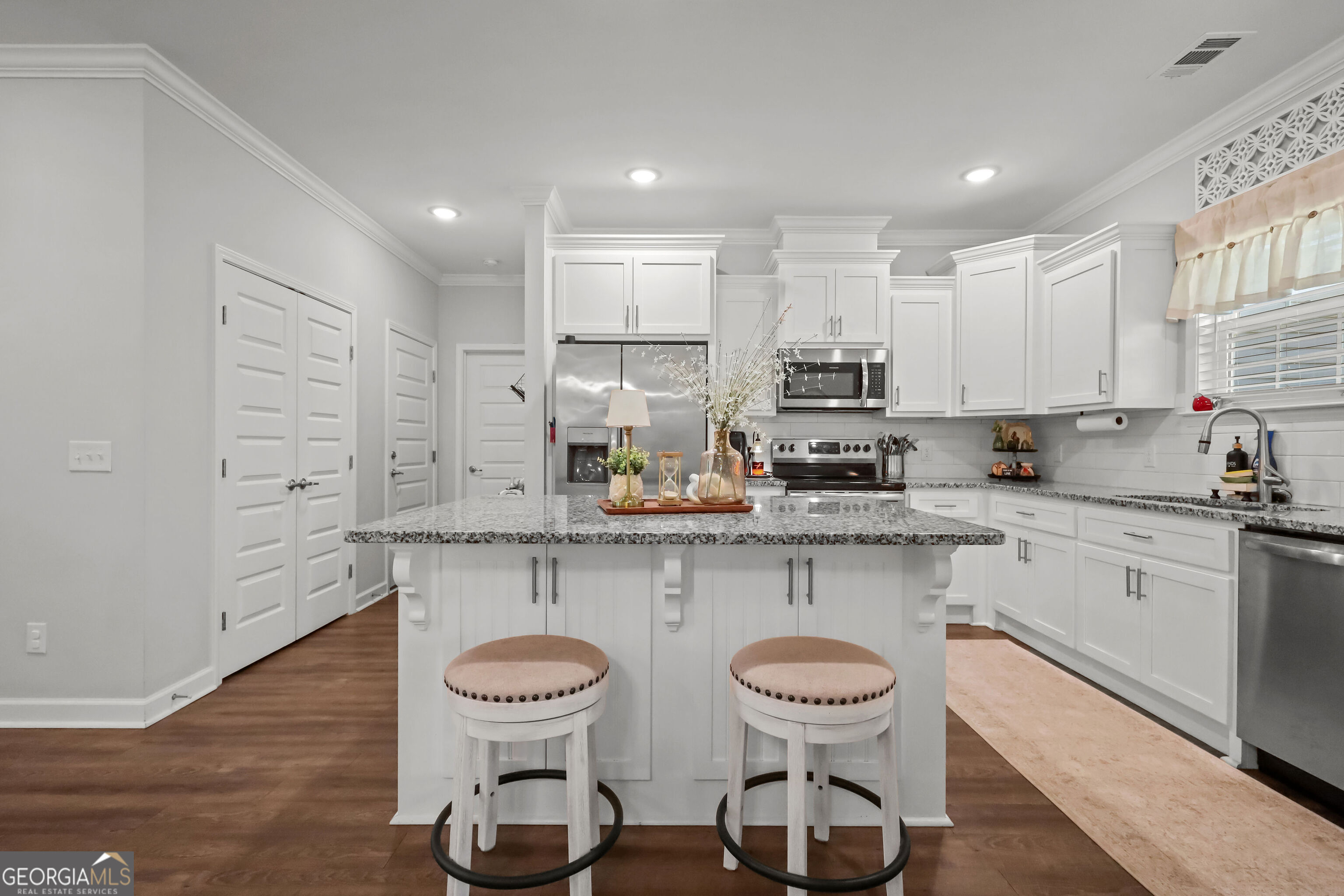 189 Common Way Jesup, GA 31545 - Photo 10 of 30 a kitchen with stainless steel appliances a table chairs refrigerator and sink