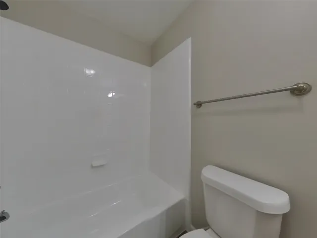 a bathroom with a toilet and a bathtub
