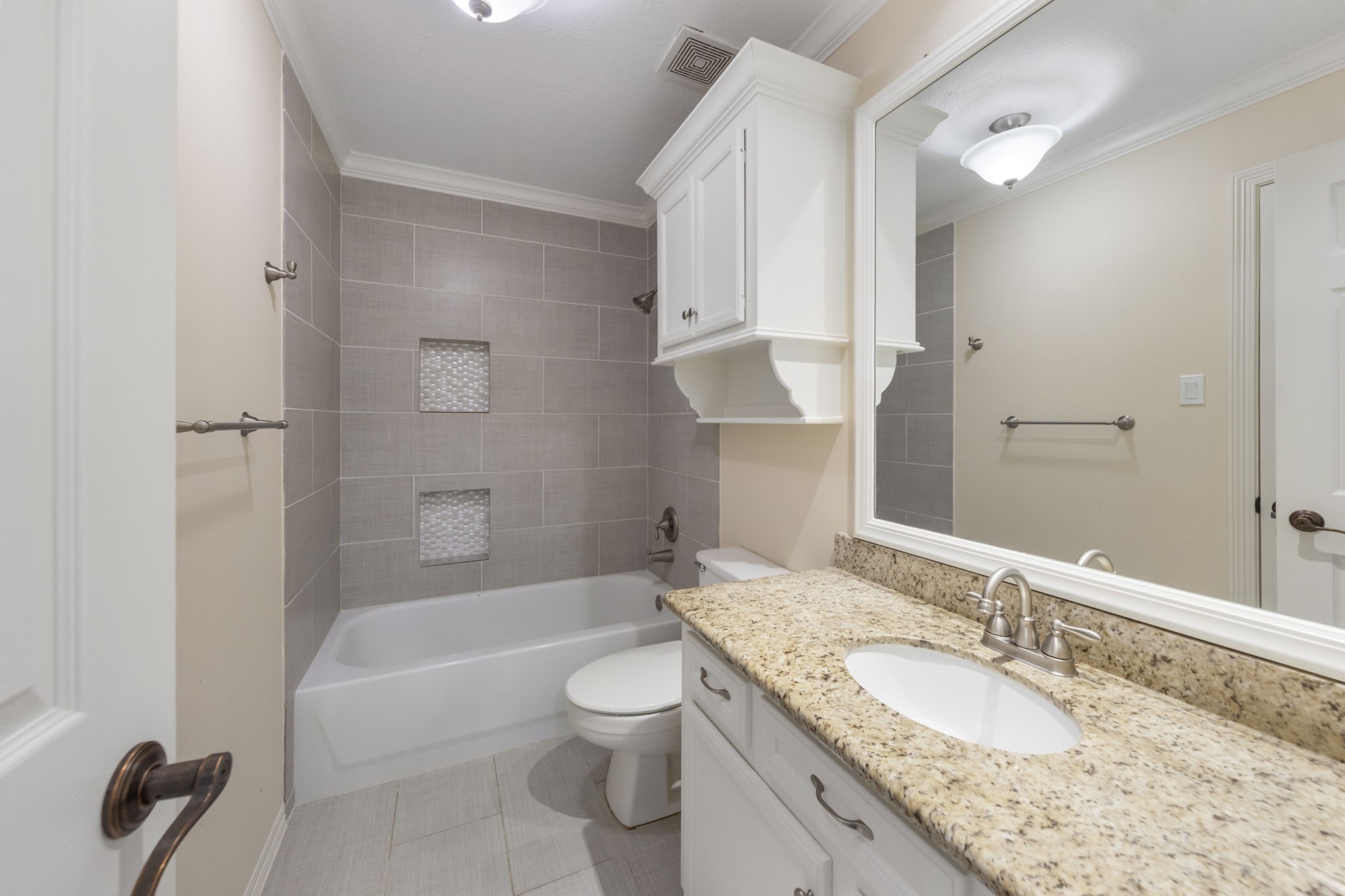 90 West Horizon Ridge Place Spring, TX 77381 - Photo 21 of 36 a bathroom with a granite countertop sink a toilet and bathtub