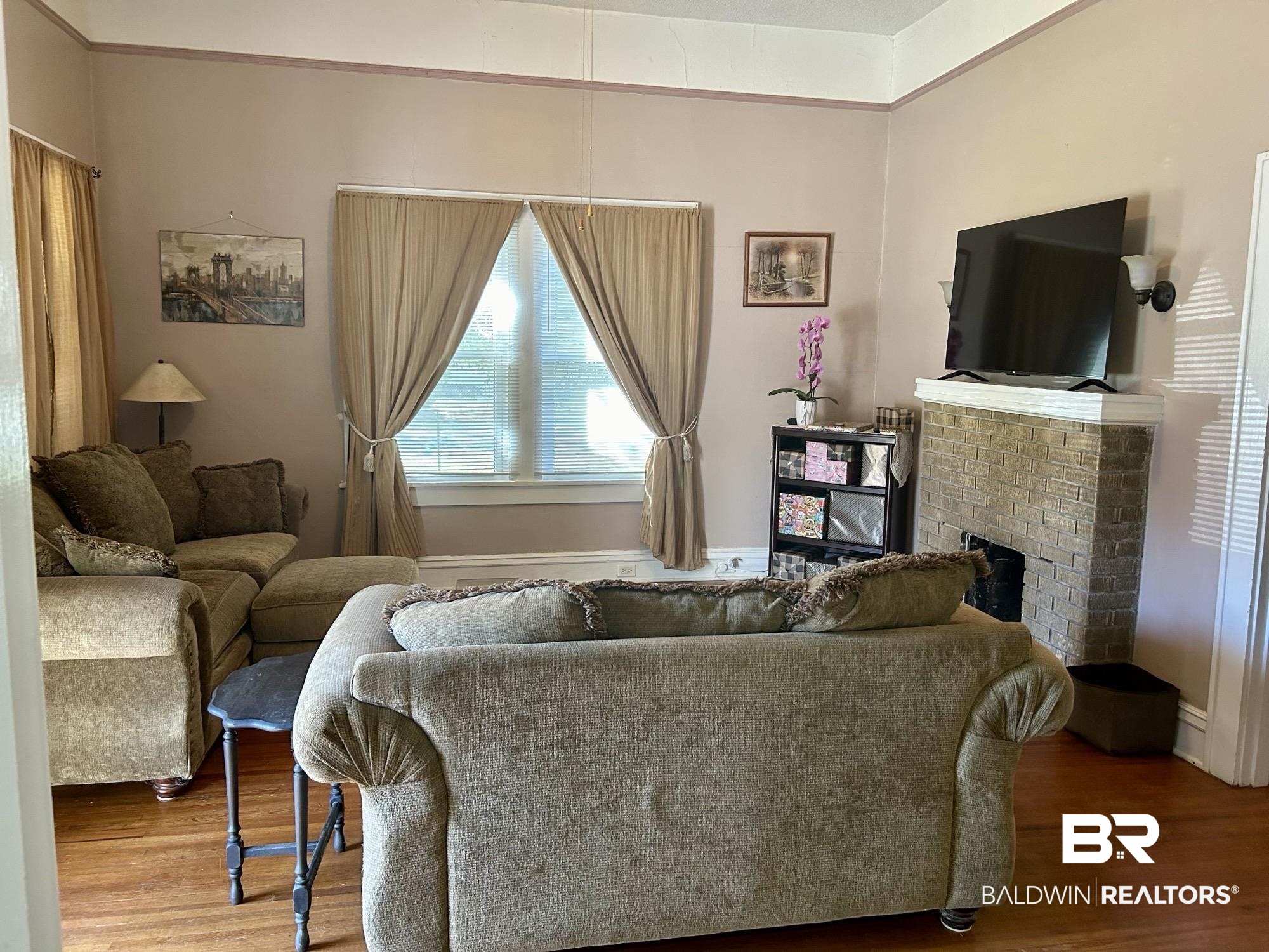 405 North Wasson Avenue Mobile, AL 36612 - Photo 3 of 26 Living room with a brick fireplace and hardwood flooring