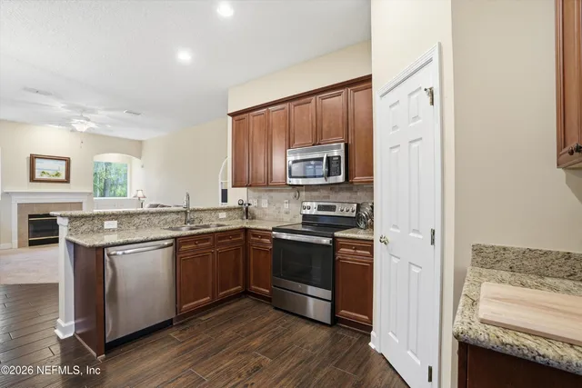 a kitchen with stainless steel appliances granite countertop a stove and a sink