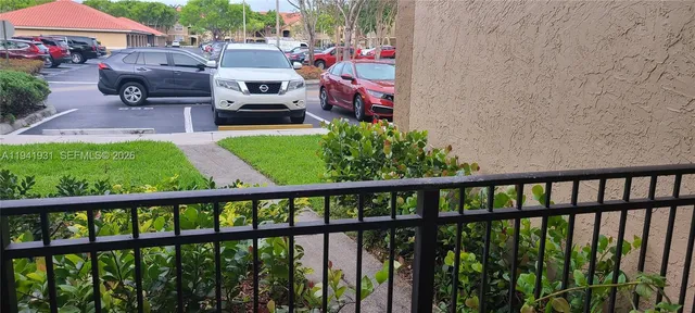 a view of a room with furniture and wooden floor
