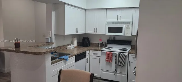 a kitchen that has a sink and a stove