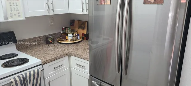 a kitchen with a refrigerator and a stove