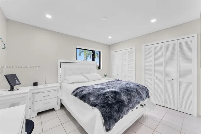 a spacious bedroom with a bed and a walk in closet