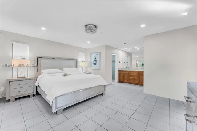 a large bedroom with a bed and a view of closet