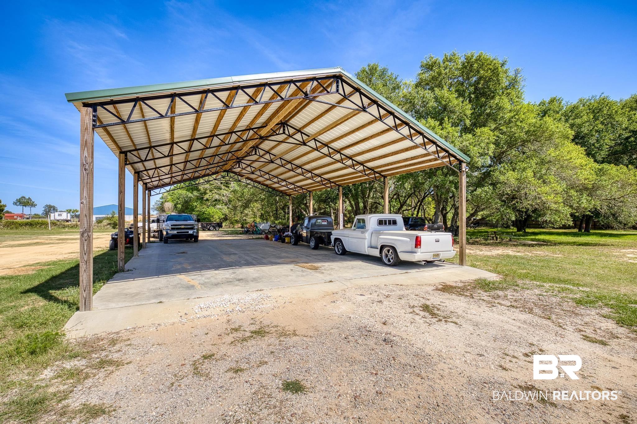 32875 Faircloth Road Lillian, AL 36549 - Photo 66 of 85 View of parking with a detached carport and driveway