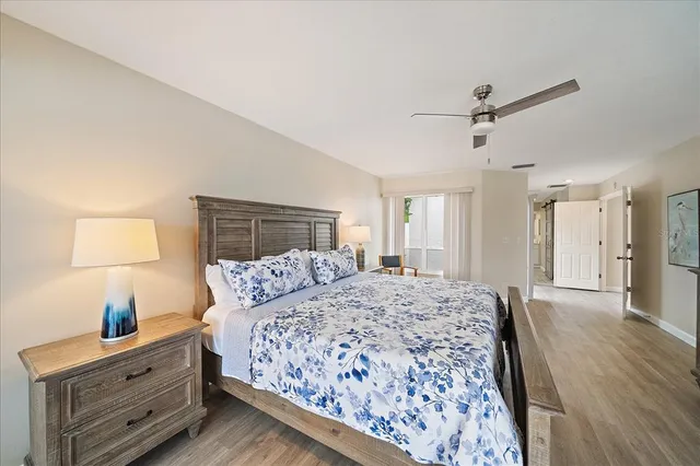 a bedroom with a bed and a lamp on dresser