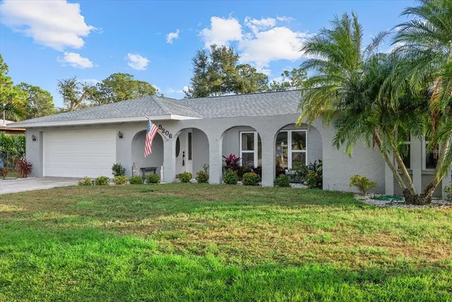 a front view of house with yard and green space