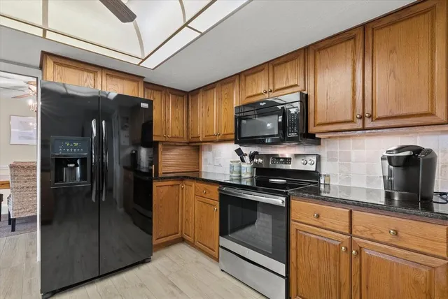 a bathroom with a granite countertop sink a mirror and a shower