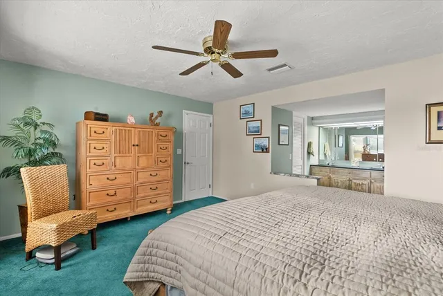 a dining room with furniture a potted plant and a floor to ceiling window