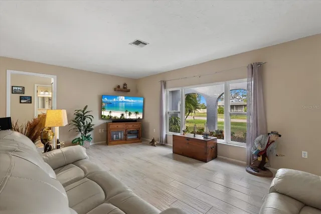 a kitchen with stainless steel appliances granite countertop wooden cabinets a sink a stove and a wooden floors