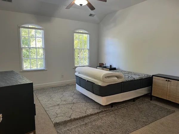 a bedroom with a bed and window
