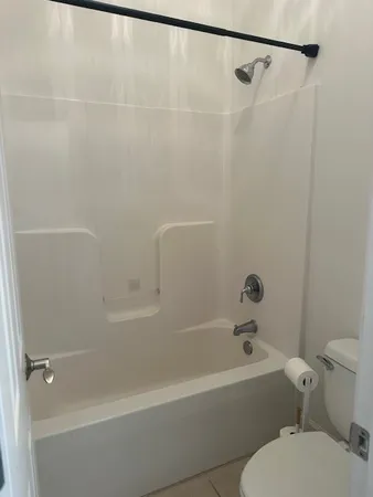 a bathroom with a bathtub and a toilet