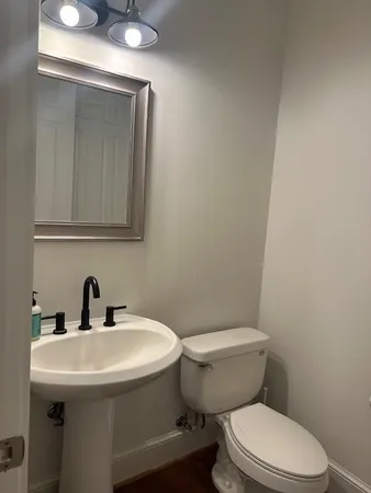 a bathroom with a sink a toilet and mirror