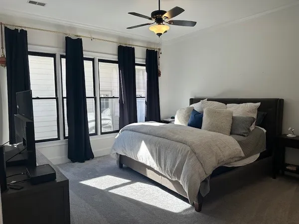 a bedroom with a large bed and a window