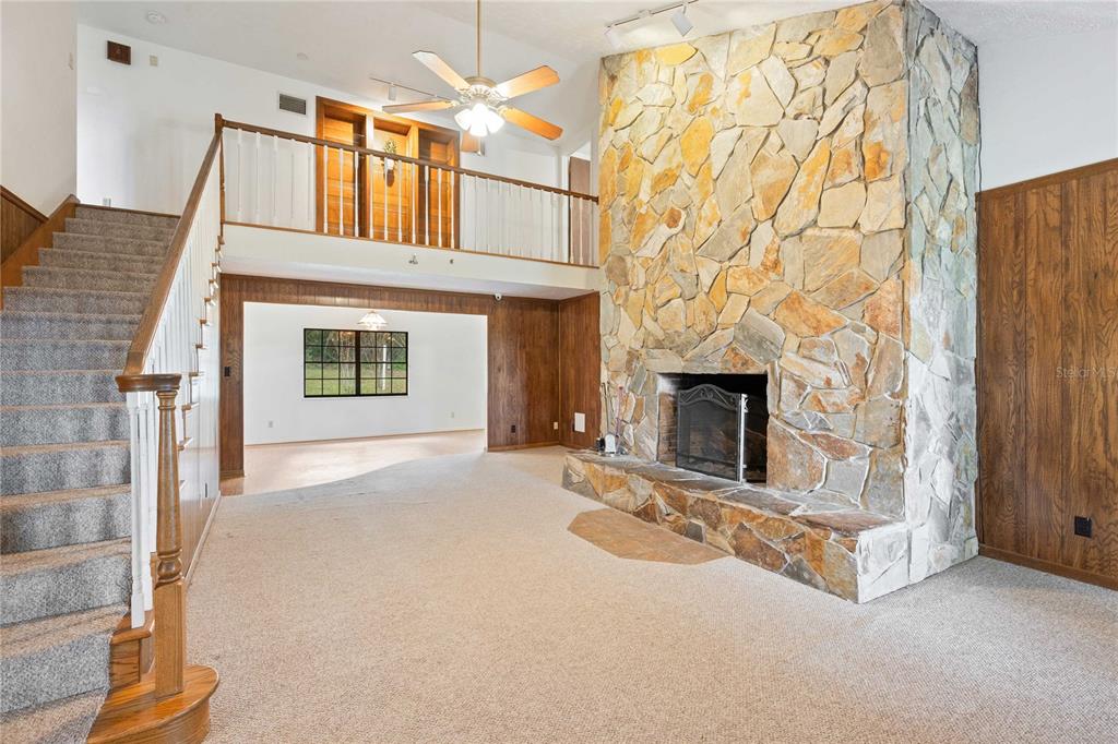 14835 Ramsey Road Dade City, FL 33523 - Photo 16 of 59 a view of a livingroom with an empty space and a fireplace
