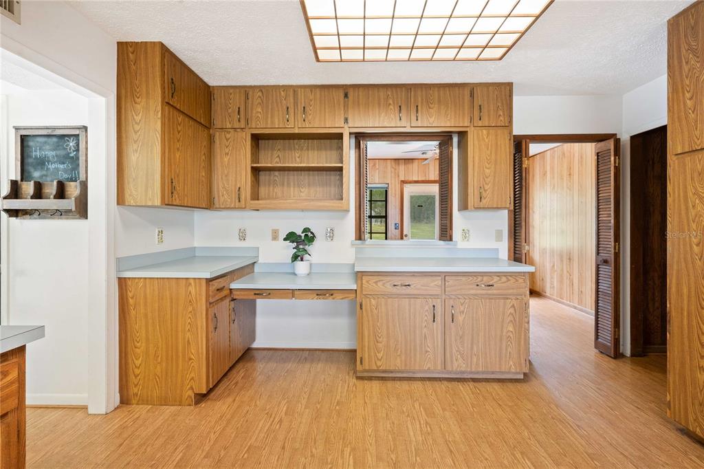 14835 Ramsey Road Dade City, FL 33523 - Photo 23 of 59 a kitchen with stainless steel appliances granite countertop a stove a sink and a refrigerator
