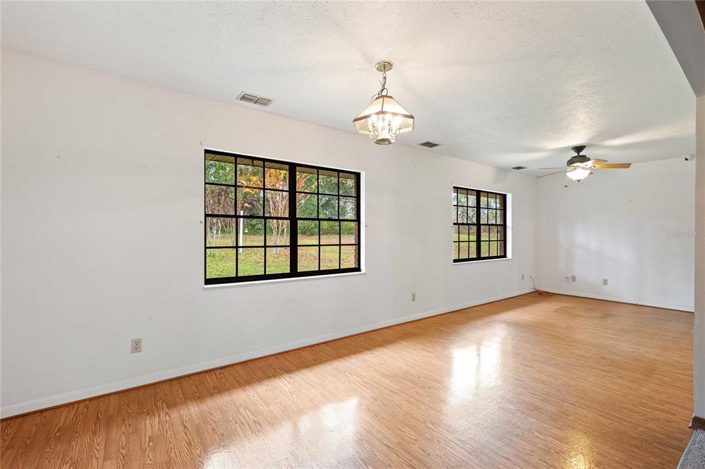 14835 Ramsey Road Dade City, FL 33523 - Photo 27 of 59 wooden floor in an empty room with a window