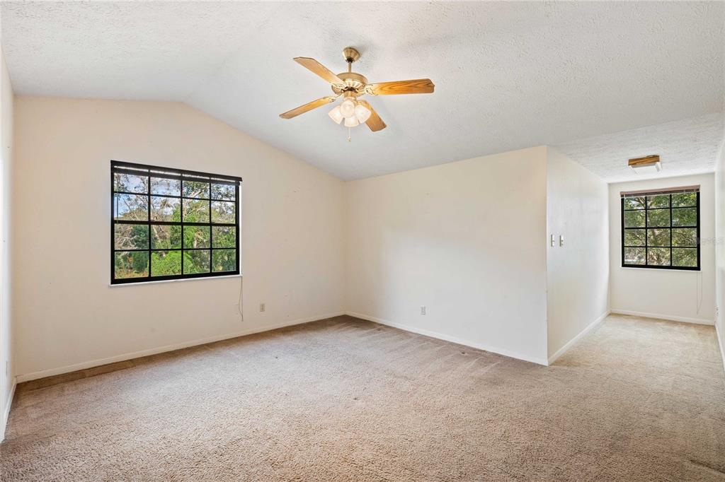 14835 Ramsey Road Dade City, FL 33523 - Photo 35 of 59 an empty room with windows and ceiling fan