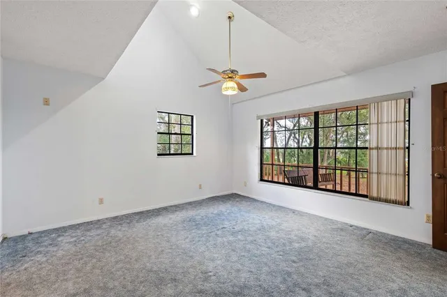 a view of a house with a backyard and a small pool