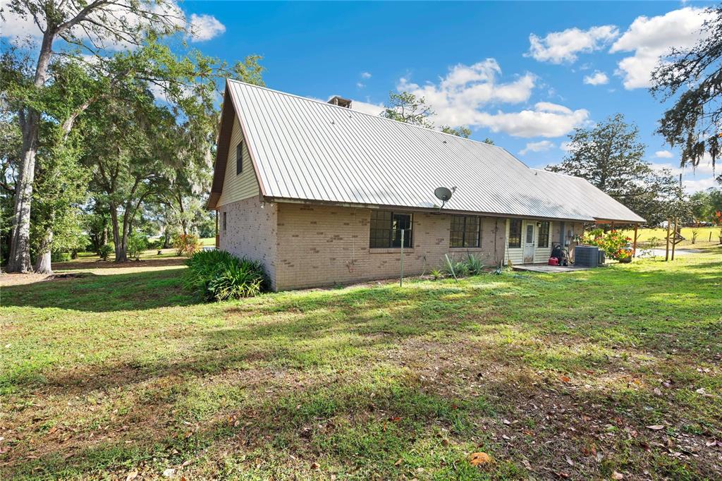 14835 Ramsey Road Dade City, FL 33523 - Photo 45 of 59 a front view of a house with a garden