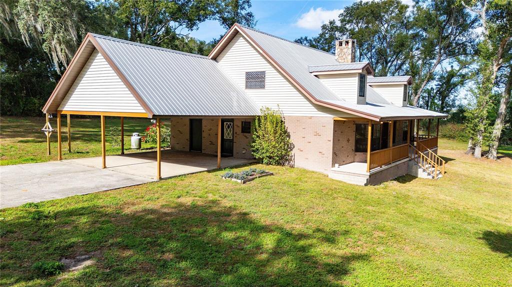 14835 Ramsey Road Dade City, FL 33523 - Photo 53 of 59 a view of a house with a backyard and a small pool