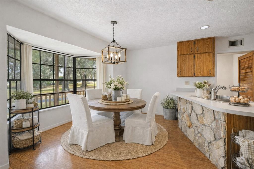 14835 Ramsey Road Dade City, FL 33523 - Photo 8 of 59 a view of a dining room with furniture window and wooden floor