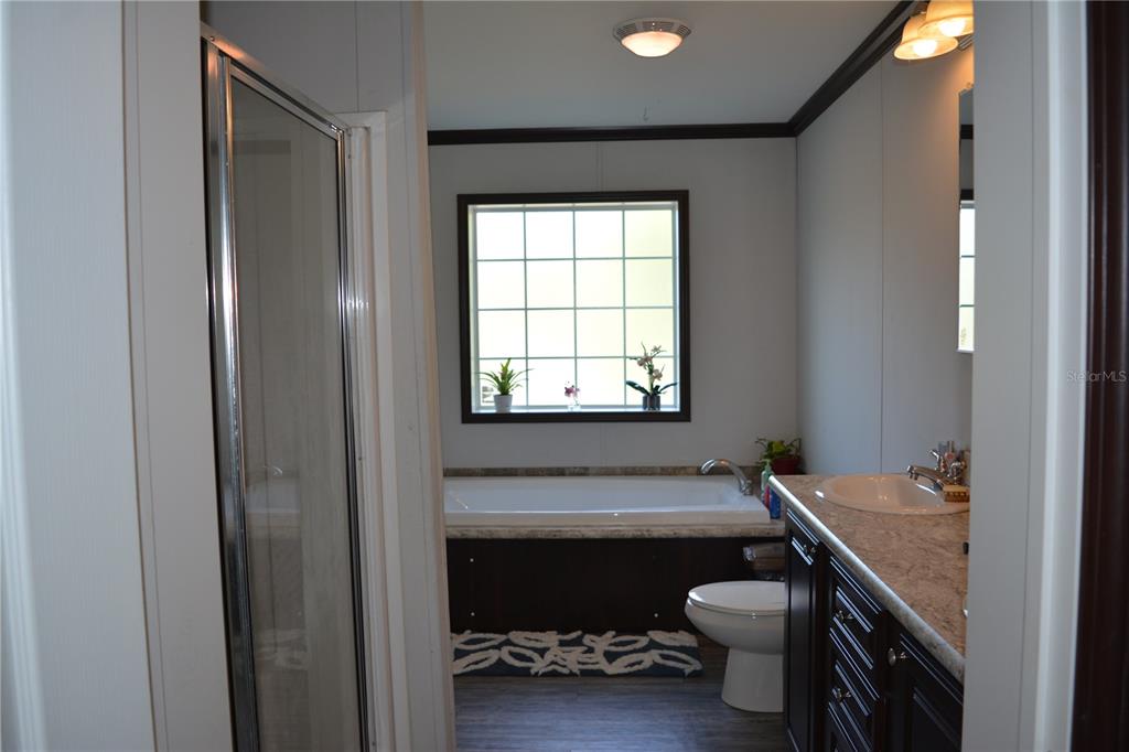 2640 Northeast 74th Street High Springs, FL 32643 - Photo 11 of 39 a bathroom with a sink a toilet and a window
