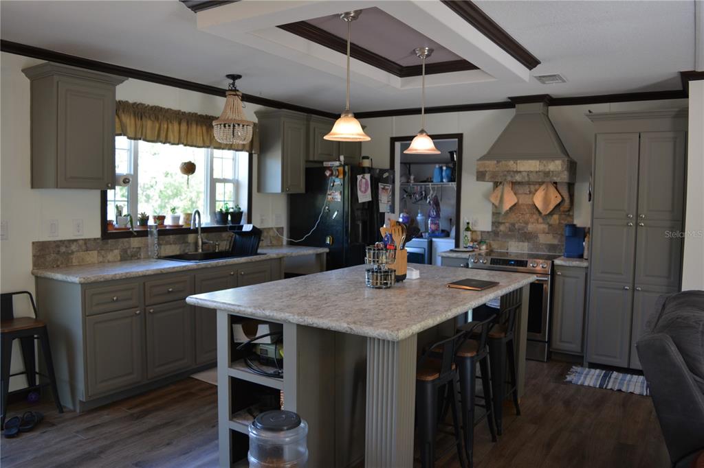 2640 Northeast 74th Street High Springs, FL 32643 - Photo 2 of 39 a room with stainless steel appliances kitchen island a table and chairs in it