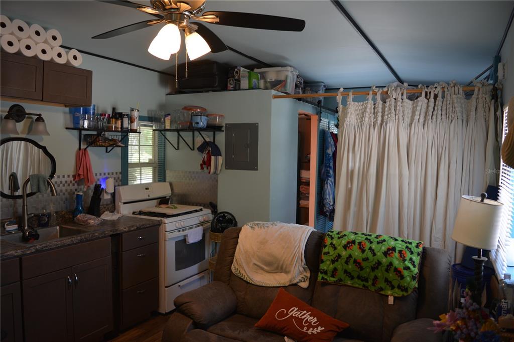 2640 Northeast 74th Street High Springs, FL 32643 - Photo 27 of 39 a bedroom with furniture a chandelier fan and a window