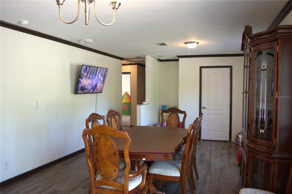 2640 Northeast 74th Street High Springs, FL 32643 - Photo 7 of 39 a view of a dining room with furniture window and wooden floor