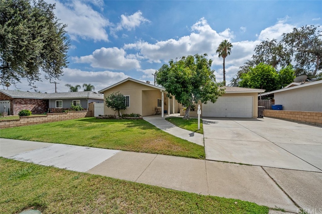 8232 Marie Street Riverside, CA 92504 - Photo 1 of 1 a front view of house with yard and green space